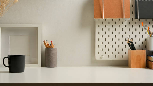 istock Workspace with stationery, mock up frame, supplies on shelf and copy space in home office 1289300621