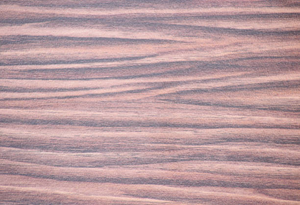 istock Mahogany with a pattern in a wide black stripe, a flat surface of natural wood close-up. 1289301448