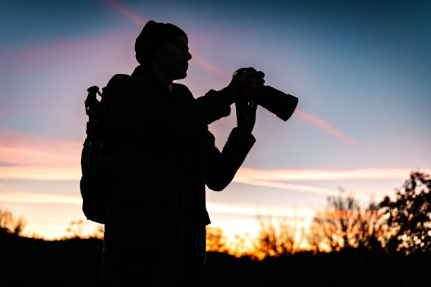 Young photographer making photographs of mountain range