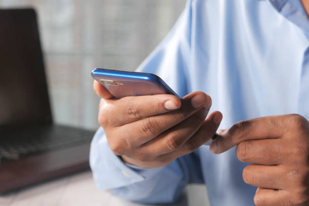 istock Close up of young man hand using smart phone. 1289303367