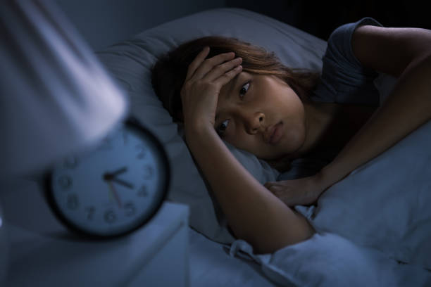 istock Depressed young woman lying in bed cannot sleep from insomnia 1289303657