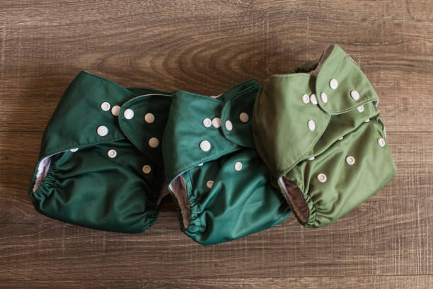 istock Green Reusable Cloth Diapers on a Wooden Floor 1289303734