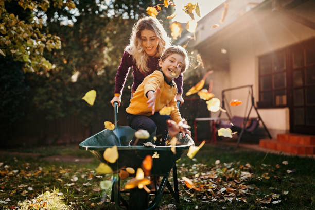 Crazy as always Mother and son playing in backyard with gardening equipment recreational pursuit stock pictures, royalty-free photos & images