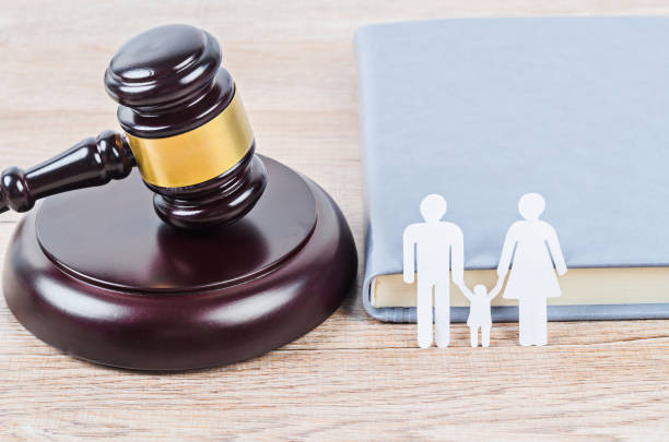 istock Family figure and gavel on table. 1289305603