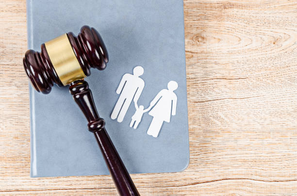 istock Family figure and gavel on table. 1289305605