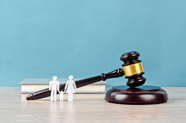 istock Family figure and gavel on table. 1289305606