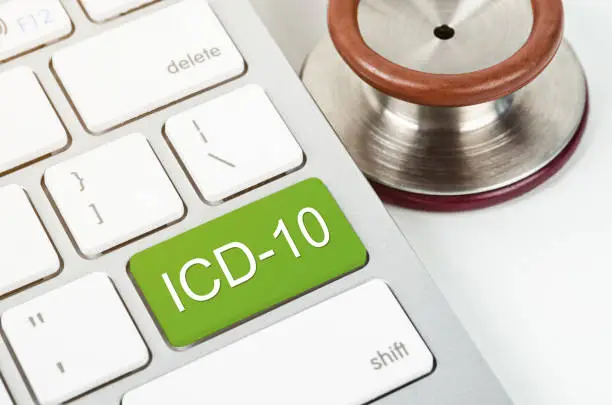 International Classification of Diseases and Related Health Problem 10th Revision or ICD-10 and stethoscope medical on computer keyboard.