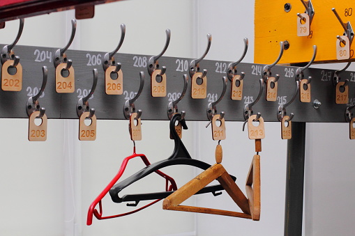 Empty hangers in a school wardrobe waiting for students, close-up. End of quarantine and self-isolation concept.