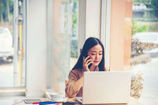 istock woman working on a laptop in cafe. 1289311250