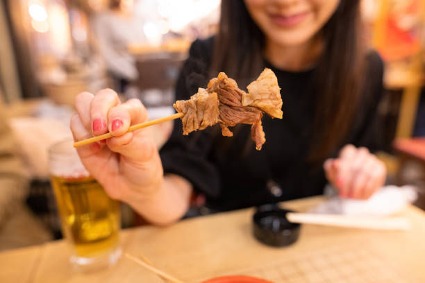 istock Young woman visiting Izakata bar after work 1289311519