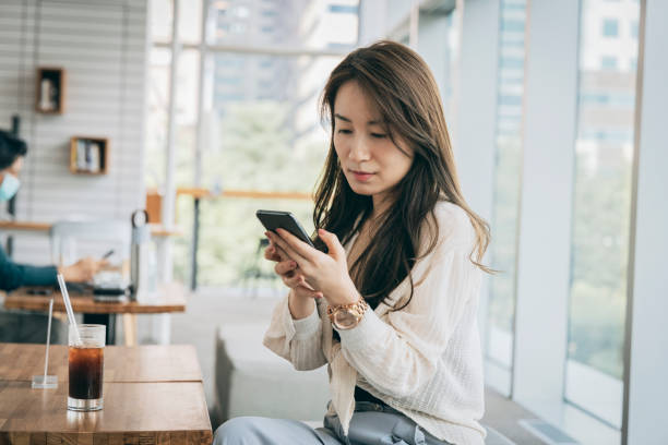 istock Asian woman working in cafe 1289317449