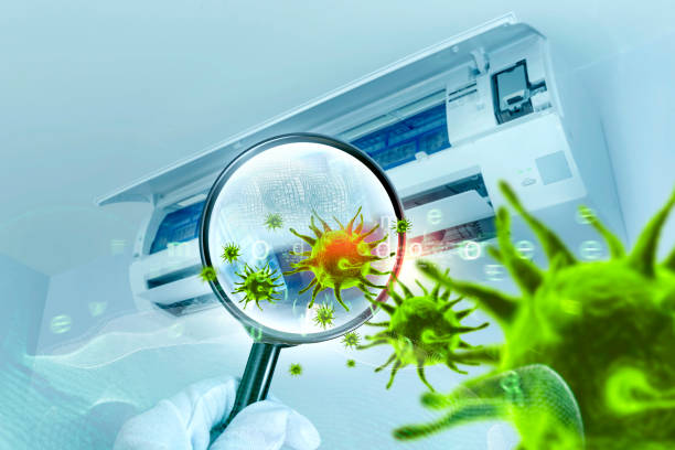 istock 3D simulation of viruses inside the air conditioner filter by showing through a magnifying glass 1289317466