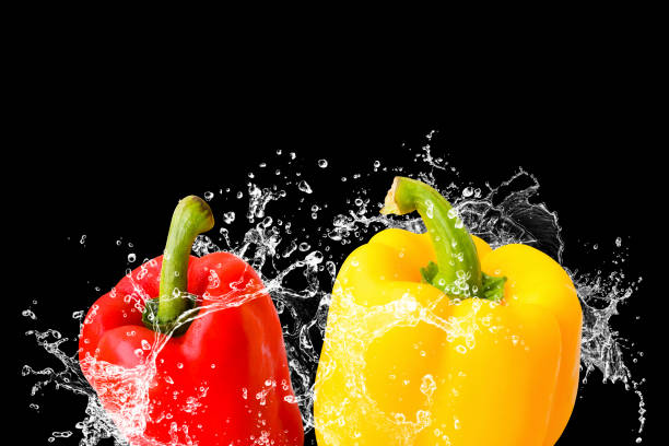 istock Fresh peppers chili red, yellow with water splash isolated on black background 1289320102