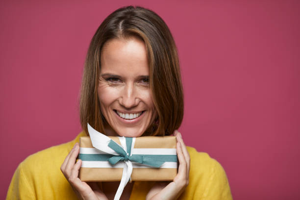 istock One woman holds proudly a Saint Valentine's gift. 1289321940