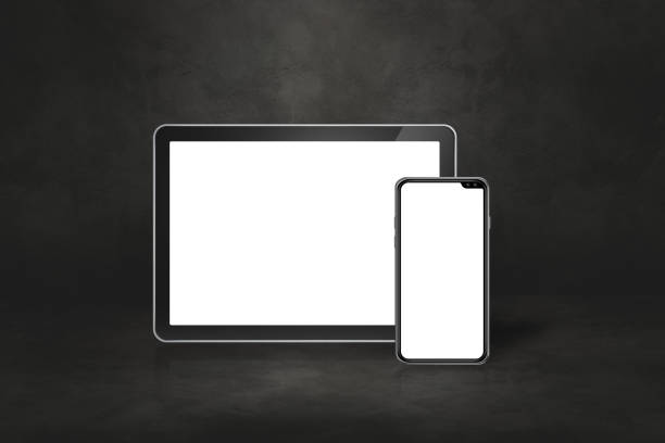 istock Mobile phone and digital tablet pc on dark concrete office scene 1289325153