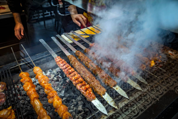 chef cooks steaks on the grill