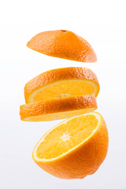 istock Oranges whole and sliced on white background in studio 1289331243
