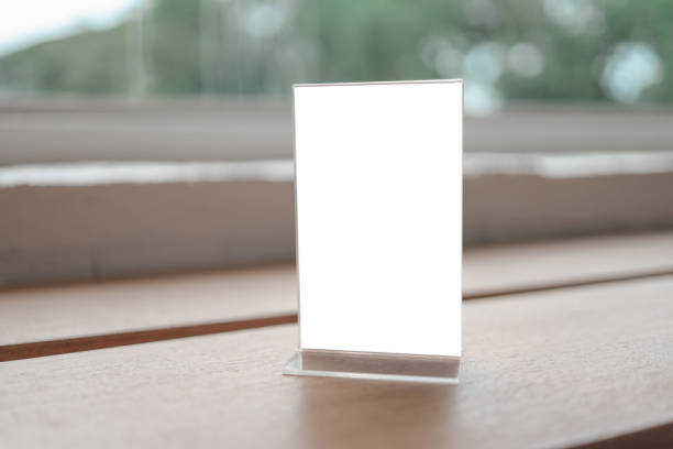 istock Mock up Menu frame standing on wood table in Bar restaurant cafe. space for text. 1289334440