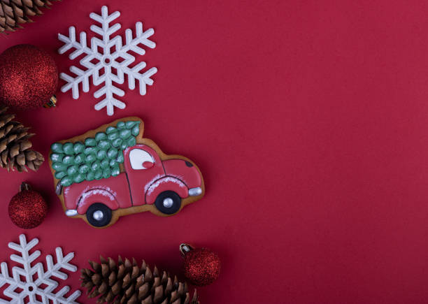 istock Christmas background with fir cones and gingerbread machine on red canvas background 1289340696