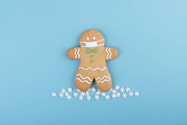 istock gingerbread man with a mask on his face 1289340811