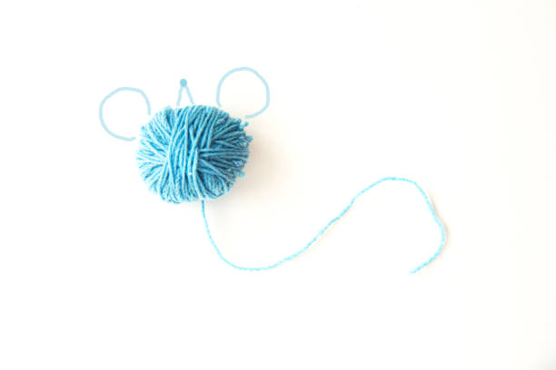 Needle and blue thread isolated on white.