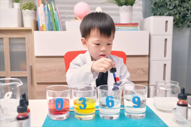 istock Little Asian kindergarten kid studying science, making Sugar Water Density Experiment, Kid-friendly fun and easy science experiments at home 1289341825