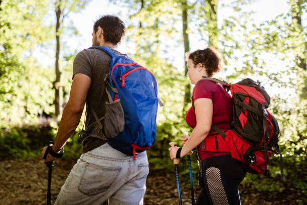 istock Young couple climbing the mountain 1289341986