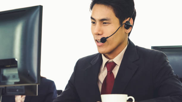 istock Business people wearing headset working in office 1289345425