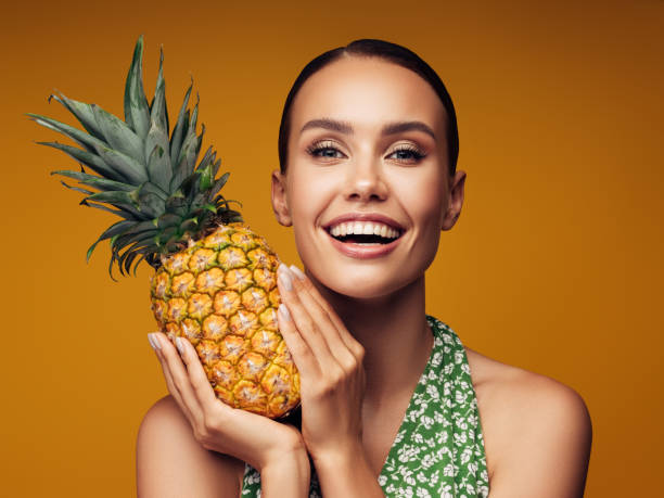 istock Beautiful girl with pineapple 1289346445