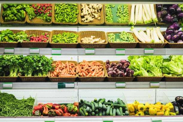 istock Fresh vegetables on supermarket shelves with empty price tags. 1289346800