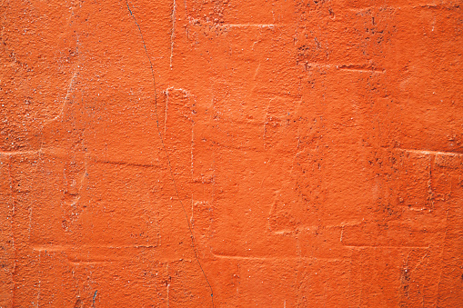 Concrete orange colorful wall surface texture. Abstract grunge bright color background with aging effect. Copyspace