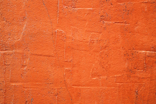 concrete orange colorful wall surface texture. abstract grunge bright color background with aging effect. copyspace. - orange wall imagens e fotografias de stock