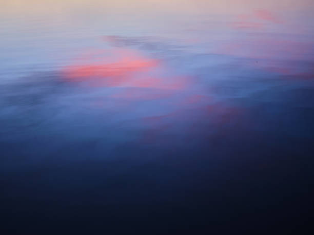 istock Reflection in water of a colourful sky 1289347071