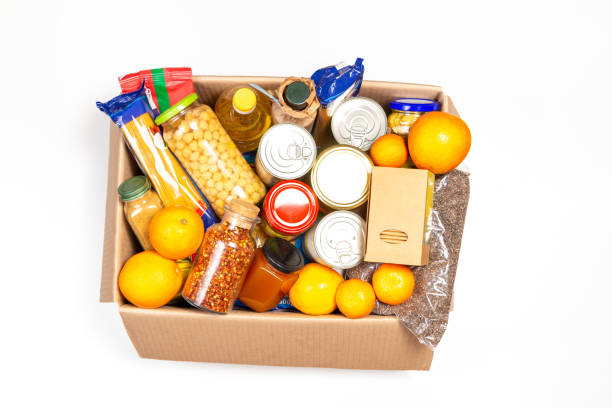 istock Food donations box with grocery products on white background. Top view 1289347795