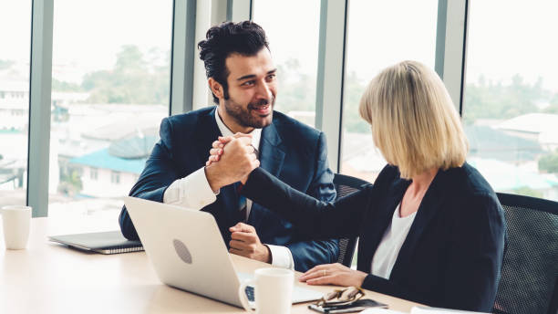 istock Two happy business people celebrate at office 1289348167