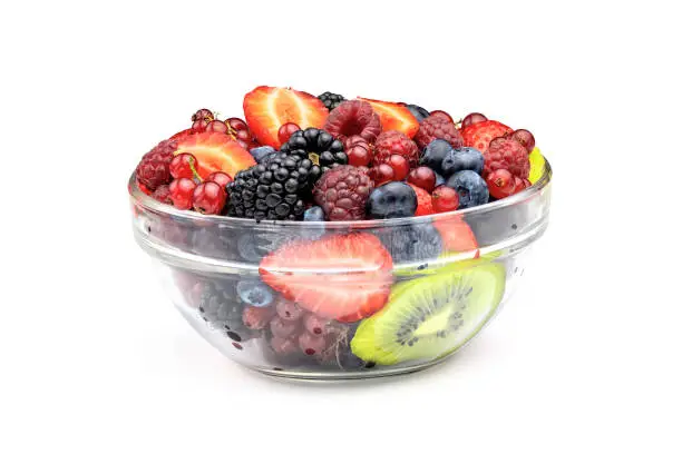 Photo of Fruit salad in glass bowl isolated on white background.