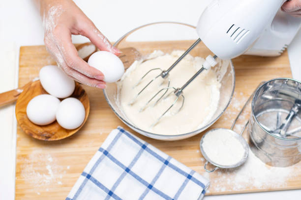istock process of making dough for pancakes with ingredients on a light table, eggs and flour are whipped with a mixer 1289351310