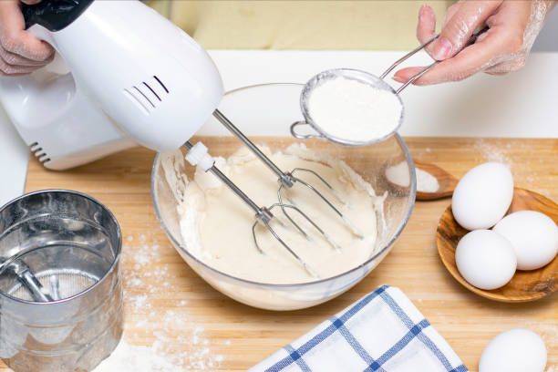 istock process of making dough for pancakes with ingredients on a light table, eggs and flour are whipped with a mixer 1289351334