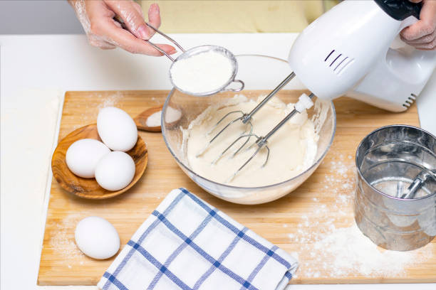 istock process of making dough for pancakes with ingredients on a light table, eggs and flour are whipped with a mixer 1289351372