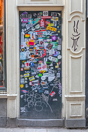 Amsterdam, Netherlands - May 15, 2018: Door Covered With Stickers at House in Amsterdam, Holland.