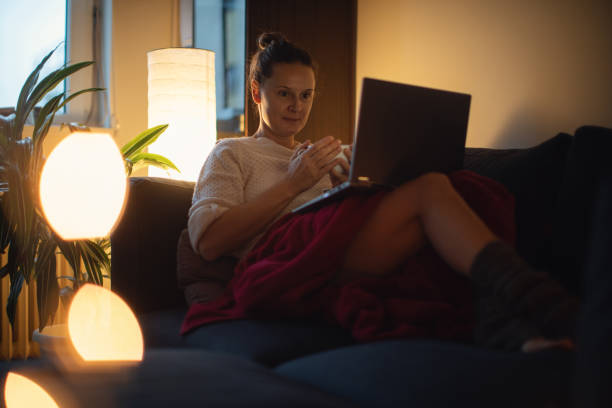 istock Woman drinking tea alone at home 1289351690