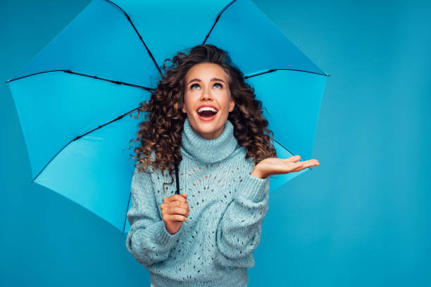 istock Girl with blue umbrella 1289352373