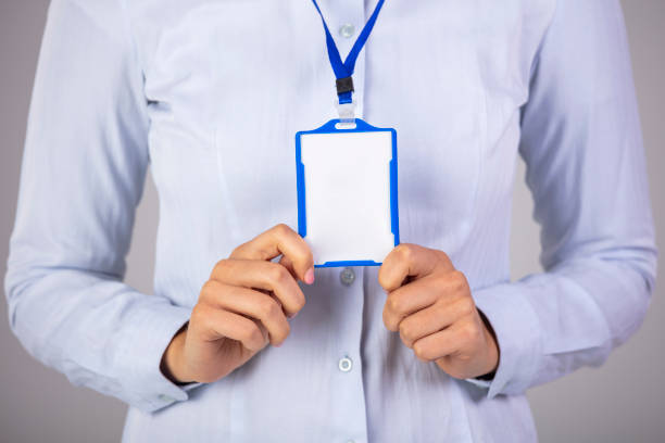 istock Woman holding Identification white blank plastic id card 1289352519