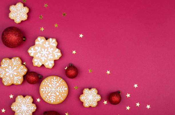 istock gingerbread snowflakes on a dark red background with copy space for text 1289352743