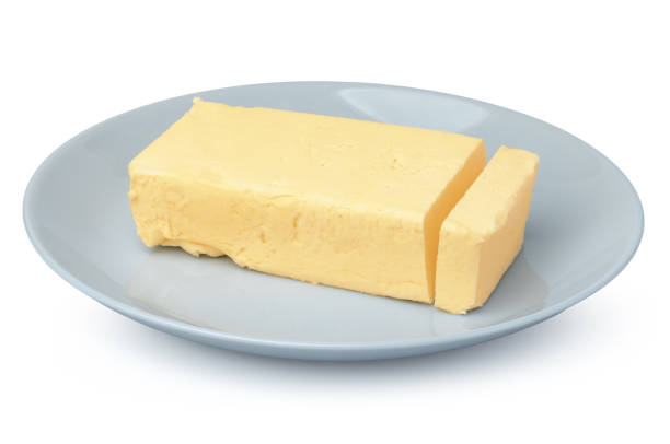 istock Butter on white plate isolated on white background 1289354456