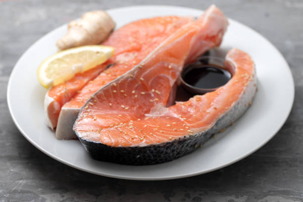istock fresh salmon with lemon, ginger and soy sauce on white plate 1289354509