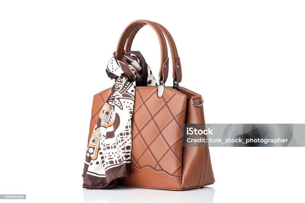 Luxury brown female hand bag and scarf isolated on white background Purse Stock Photo