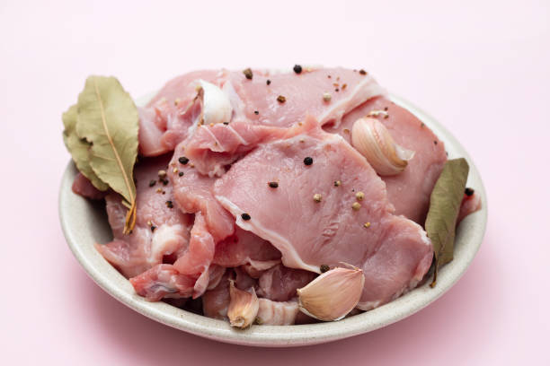 istock raw pork with black pepper, garlic and bay leaf on dish 1289354608