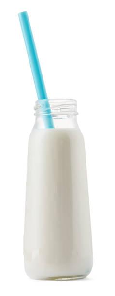 istock Glass cup of milk with a straw isolated on white 1289357218