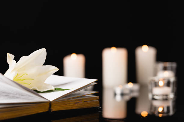 istock lily on holy bible on blurred background, funeral concept 1289357504